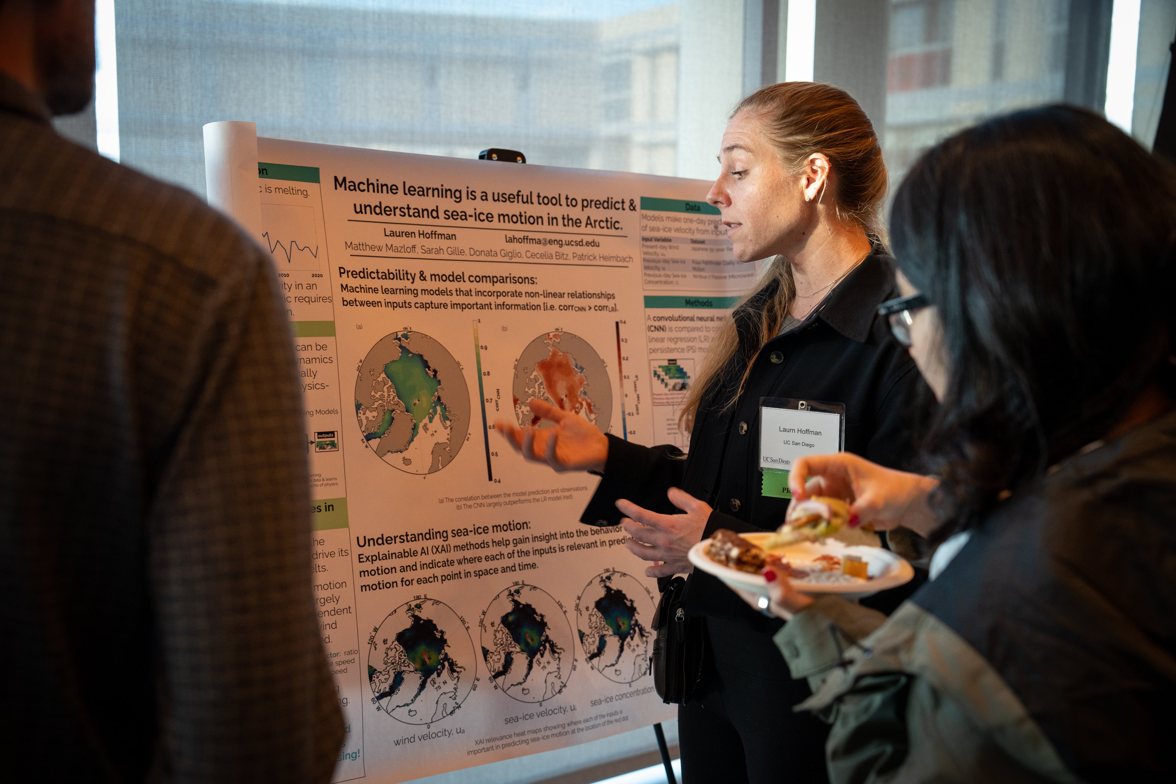 Lauren Hoffman presenting a research poster titled 'Machine learning is a useful tool to predict and understand sea-ice motion in the Arctic' to attendees at a conference poster session